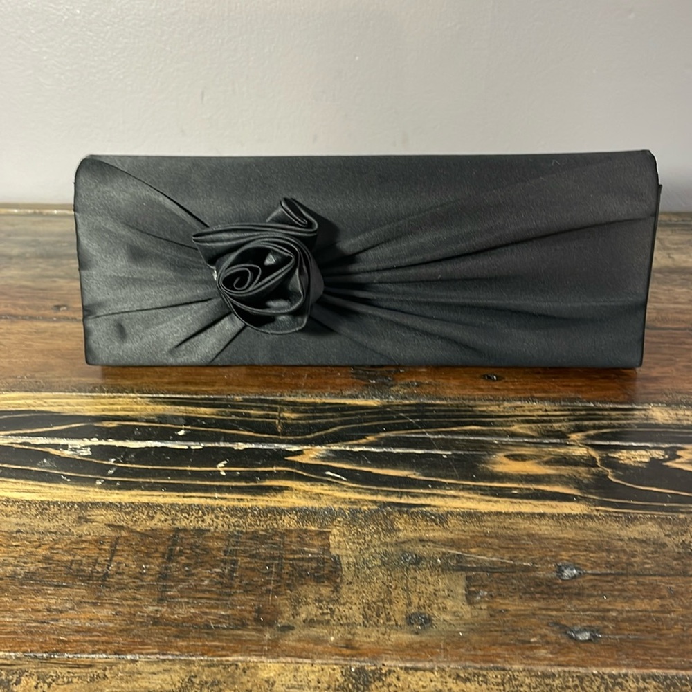Black rosette long rectangular purse by Rinaldi.  Nice length silver chain.